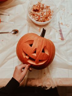 a person carving a pumpkin for halloween