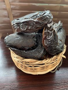 a basket filled with dried fruit sitting on top of a wooden table