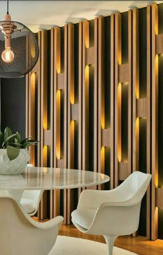 an elegant dining room with white chairs and wood paneling on the wall behind it