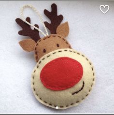 a felt ornament with a red nose and brown antlers on it's head