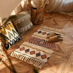 several decorative rugs and pillows on the floor