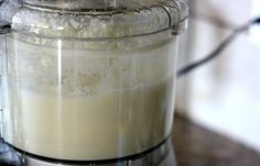 a blender filled with white liquid on top of a counter