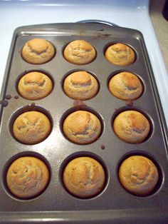 muffins sitting in a pan on top of a stove