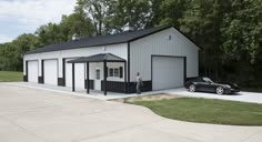 a car is parked in front of a garage with a man standing outside the door