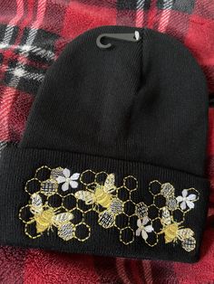 "Whimsical Golden Busy Queen Bees to keep your head warm.  Hat is 100% Acrylic, soft and warm. Hand wash only.  Hat measurements: appox. 12\" long unfolded, approx. 9\" long folded, width is approx 8 1/2\" on one side when flat, lots of stretch. Machine Embroidered." Fall Bonnet Cap, One Size Fits Most, Fall Bonnet One Size Fits Most, One Size Fits Most Fall Bonnet Cap, Adjustable Beanie For Cold Weather, Golden Queen, Bee Hat, Queen Bees, 2 On, Beanie Hat