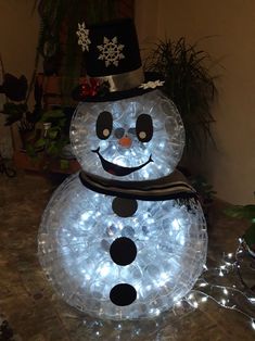 a lighted snowman with a hat and scarf