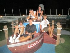 some people are sitting on a fake boat