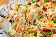 a glass bowl filled with coleslaw and carrots