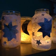 three mason jars decorated with paper stars and moon