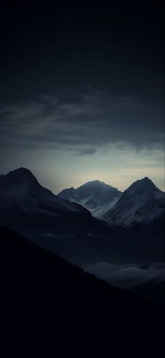 the mountains are covered in fog at night