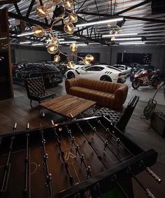 a living room filled with furniture and lots of lights hanging from it's ceiling