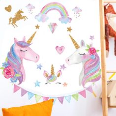 two unicorns with hearts, stars and rainbows on a white background hanging from a wooden ladder