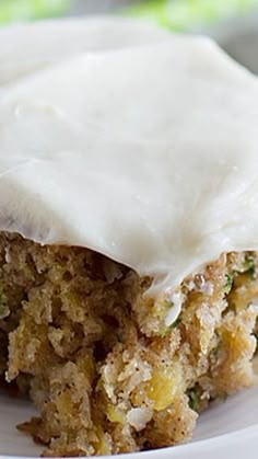 a close up of a piece of cake on a plate with white frosted topping