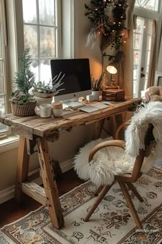 a wooden desk with a computer on top of it next to a chair and window