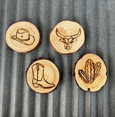 four pieces of wood that have been carved into the shape of cowboy boots and an animal's head