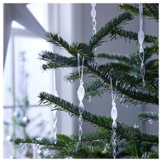 a close up of a christmas tree with beads hanging from it