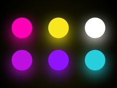 four different colored lights on a black background