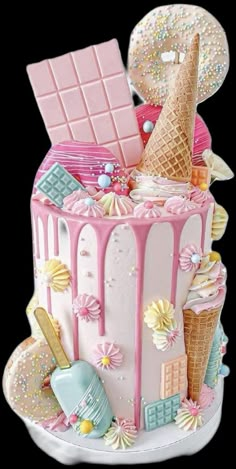 a pink cake decorated with ice cream and sweets