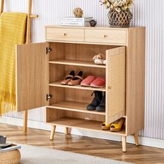 a wooden cabinet with shoes on it in front of a white wall and yellow rug