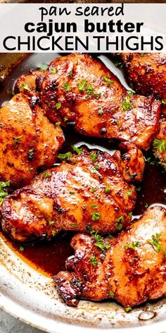 grilled chicken thighs in a skillet with parsley on top and text overlay that reads, pan - seasoned cajun butter chicken thighs