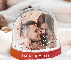 a man and woman under a glass dome with hearts on the inside that reads sedat & yeliz