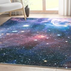 an area rug with stars and planets on it in front of a window overlooking a white chair