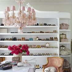 a room filled with lots of shoes and a chandelier