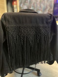 the back of a jacket with fringes on it