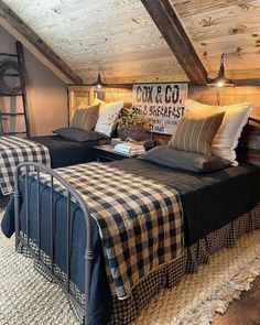 two beds in a room with wooden ceilings and plaid blankets on top of the beds