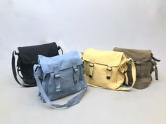 "Classic 1980s vintage but never used, Cotten canvas messenger bag.  This is a great size bag, perfect for a laptop or A4 size files. A light weight bag that can be used as carry on. The strap is adjustable and has a wider shoulder part for comfort.  Strap is adjustable but longest is 50\"  Bag laid flat measures 15\" x 11\" Easily fits a folder/book/ laptop  14\" x 9\" Side pockets 8\" deep x 4.5\" wide perfect for a water bottle there are 4 colours  available  Black  Blue  Green  Yellow  All i School Satchel Shoulder Bag In Cotton, School Crossbody Cotton Bag, Cotton Crossbody School Bag, School Cotton Crossbody Bag, Canvas Crossbody Bag For School, Canvas Satchel For School, School Crossbody Canvas Bag, Cotton Crossbody Satchel For School, School Canvas Bag Crossbody