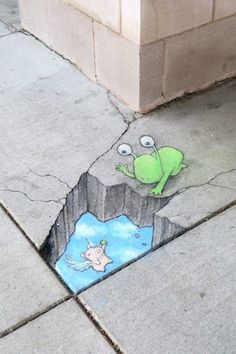 a drawing of a frog on the ground next to a sidewalk with a hole in it