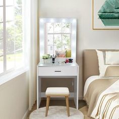 a bedroom with a bed, mirror and stool in front of a window that has lights on it