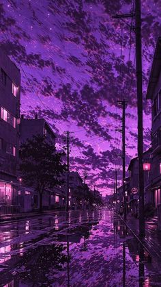 a purple sky is reflected in the water on a city street with buildings and telephone poles