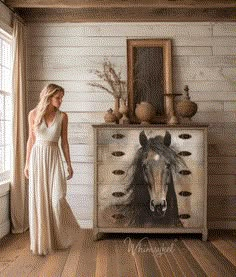 a woman standing in front of a dresser with a horse painting on it