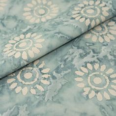 a blue and white floral print fabric with large flowers on the side, in very close up