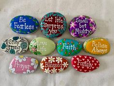 six painted rocks with words on them