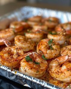 a pan filled with cooked shrimp and garnished with parsley