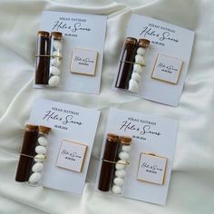 three small bottles with chocolate and white candy in them