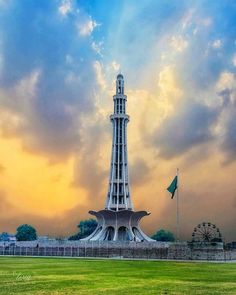 a tall tower sitting on top of a lush green field