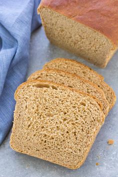 four slices of bread sitting on top of a table next to a blue cloth and napkin