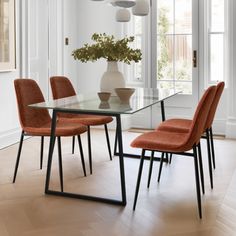 a glass table with four chairs around it