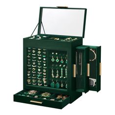 an open green jewelry box filled with lots of earrings