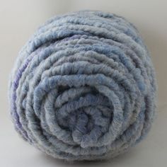 a roll of blue yarn sitting on top of a white table