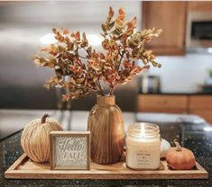 a tray with some candles and pumpkins on it