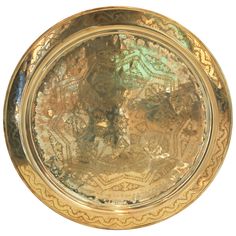 a gold plate with intricate designs on it