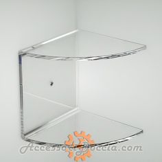 the corner shelf is made out of clear acrylic glass and has an orange star on it