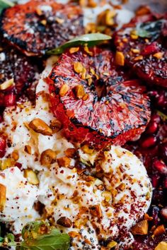 a close up of food on a plate with tomatoes and other toppings, including yogurt