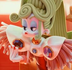 a close up of a cartoon character with wings