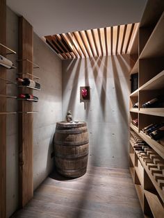 a wine cellar with wooden barrels and shelves