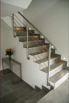 the stairs are made of metal and have glass balconies